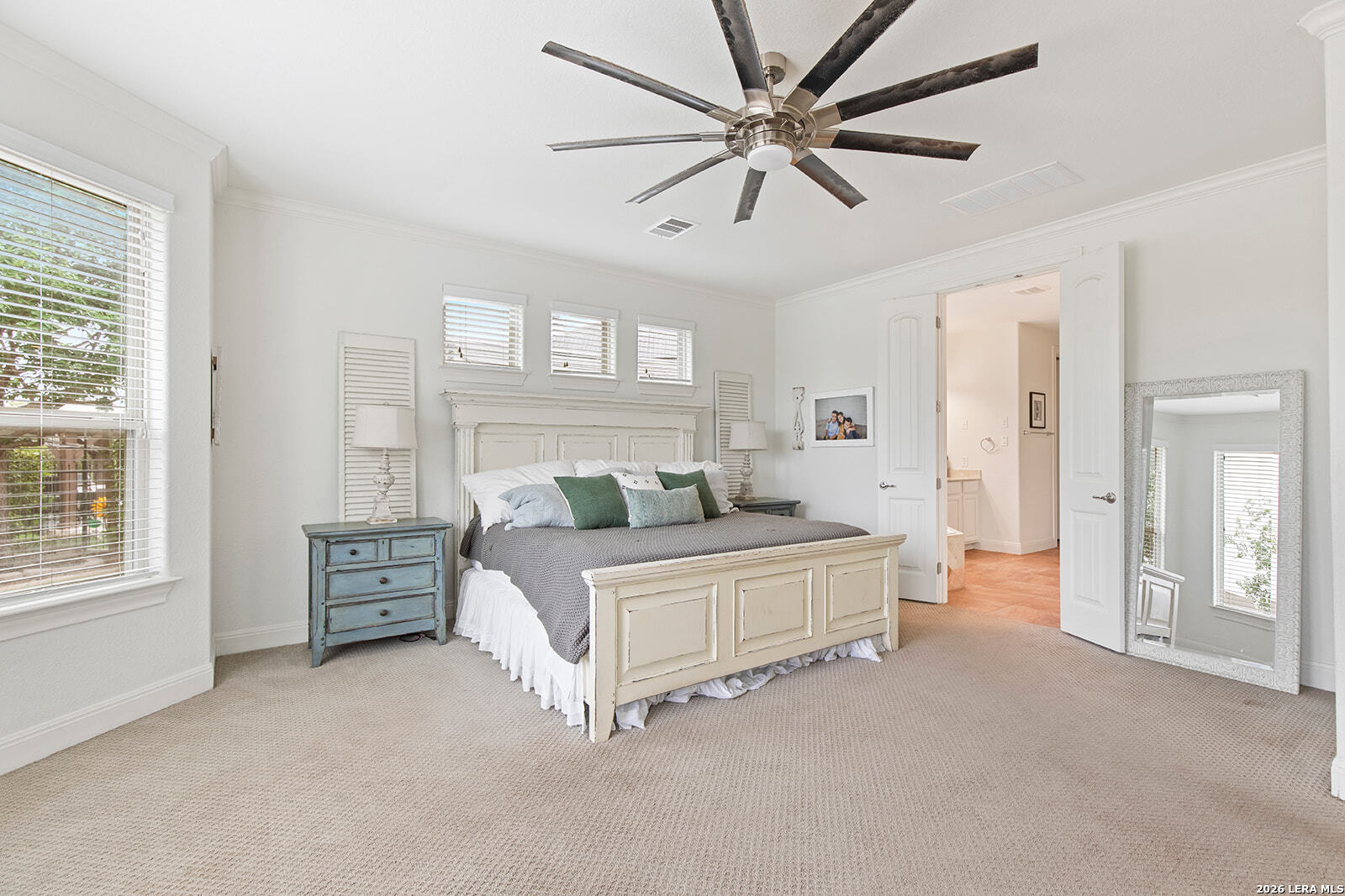 8039 Cibolo Valley Fair Oaks Ranch, TX 78015 - Photo 22 of 63 a spacious bedroom with a bed and a chandelier