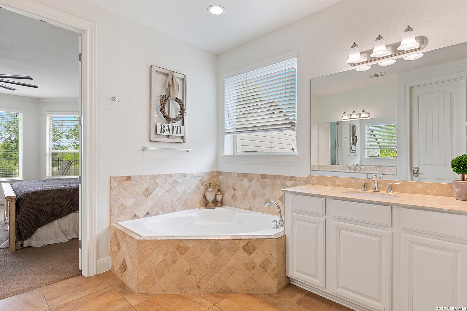 8039 Cibolo Valley Fair Oaks Ranch, TX 78015 - Photo 26 of 63 a spacious bathroom with a tub sink and mirror