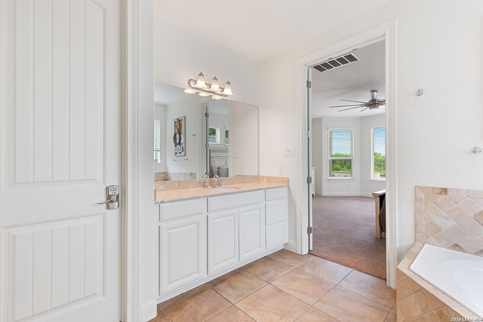 8039 Cibolo Valley Fair Oaks Ranch, TX 78015 - Photo 28 of 63 a spacious bathroom with a double vanity sink a mirror and a shower