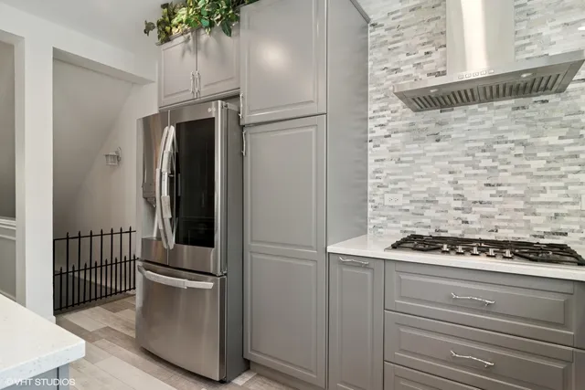 a kitchen with a refrigerator and a stove