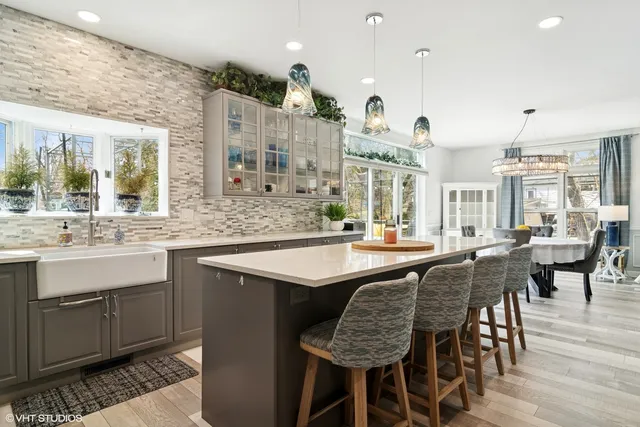 a kitchen with center island table and chairs