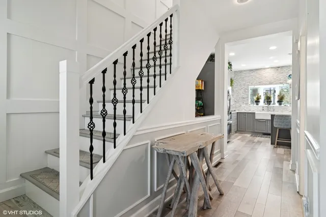 a view of entryway and hall with wooden floor