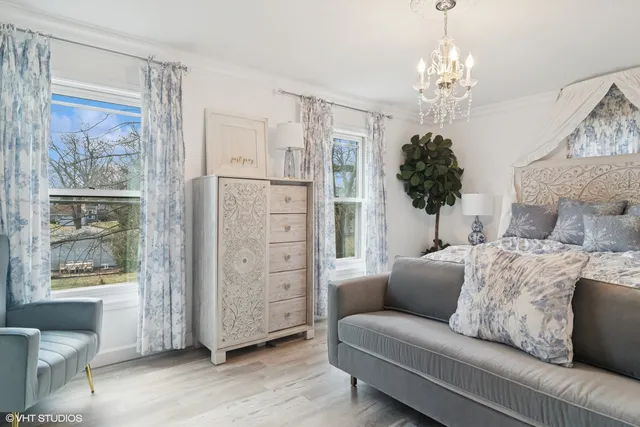 a living room with furniture and a chandelier