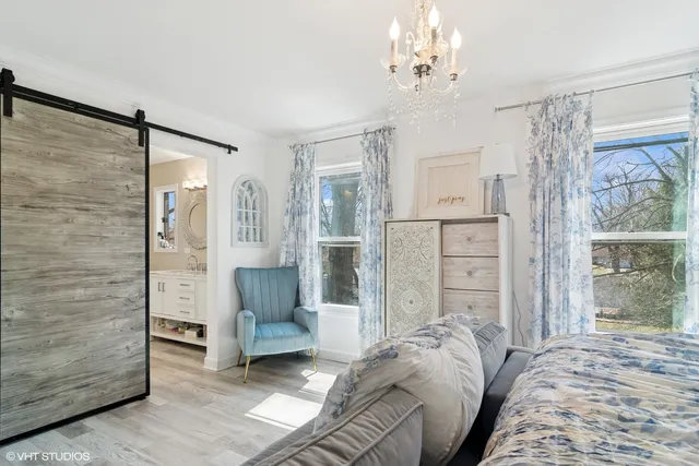 a bedroom with furniture and a chandelier