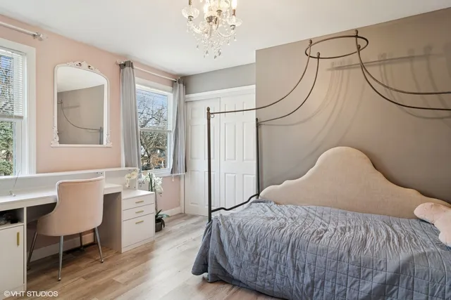 a bedroom with a bed and a chandelier