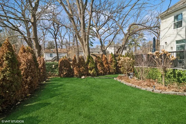 a view of a white house with a sink and garden