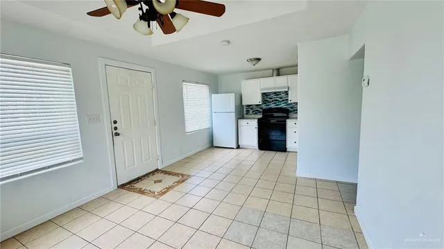 a view of a kitchen with a sink and dishwasher cabinets
