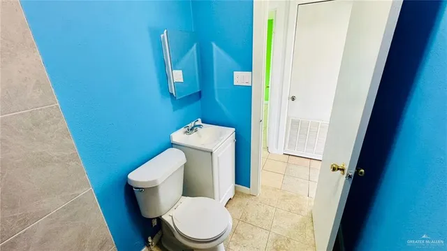 a white toilet sitting next to a small sink