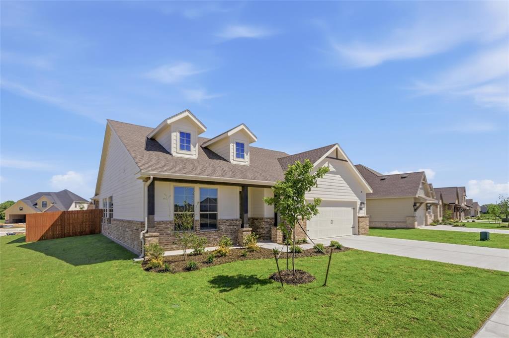 1221 Sabine River Lane Springtown, TX 76082 - Photo 4 of 25 View of front of house featuring brick siding, an attached garage, concrete driveway, and a shingled roof