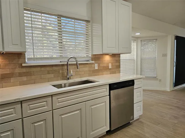 a kitchen with sink and cabinets