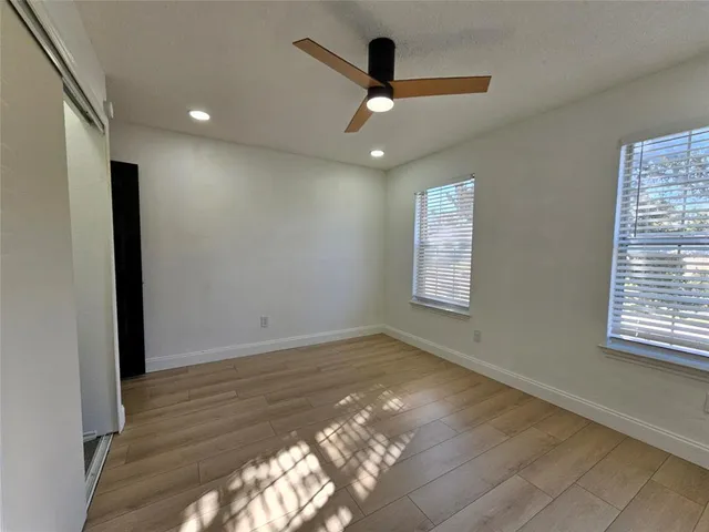 a view of a yard with plants and trees