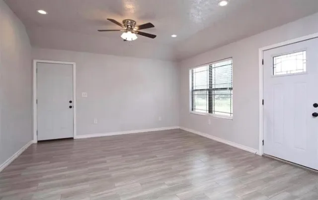 wooden floor in an empty room with a window