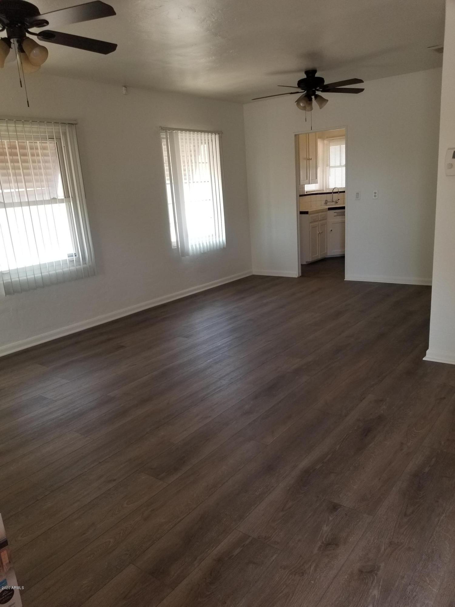 26 East Hatcher Road Phoenix, AZ 85020 - Photo 8 of 31 wooden floor in an empty room with a window