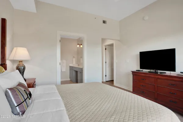 a bedroom with a bed and a flat screen television