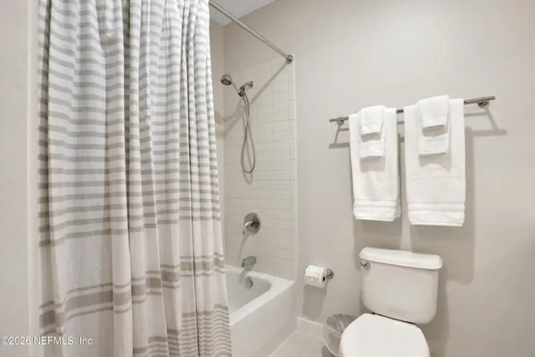 a bathroom with a toilet and shower