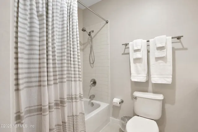 a bathroom with a toilet and shower