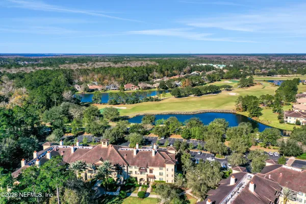 an aerial view of residential houses with outdoor space and street view