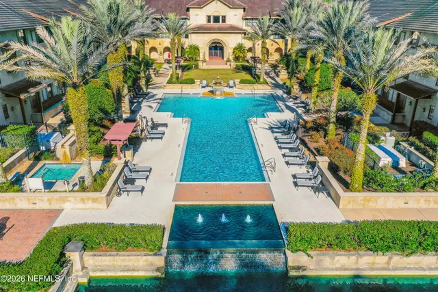 an aerial view of a house with swimming pool garden and patio