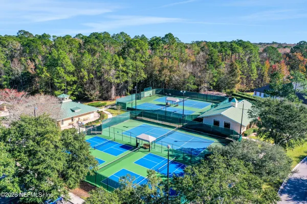an aerial view of residential houses with outdoor space and swimming pool