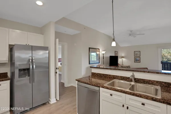 a kitchen with a refrigerator and a sink