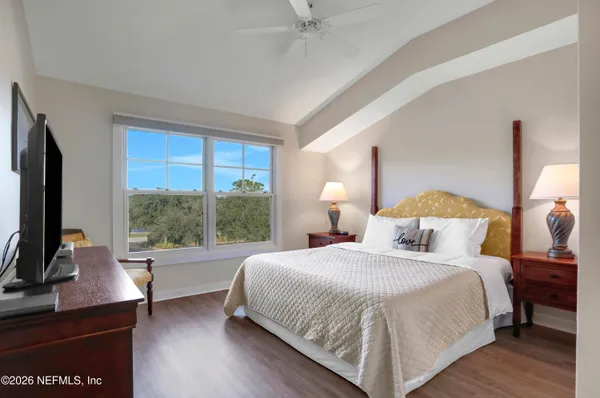 a bedroom with a bed and a large window