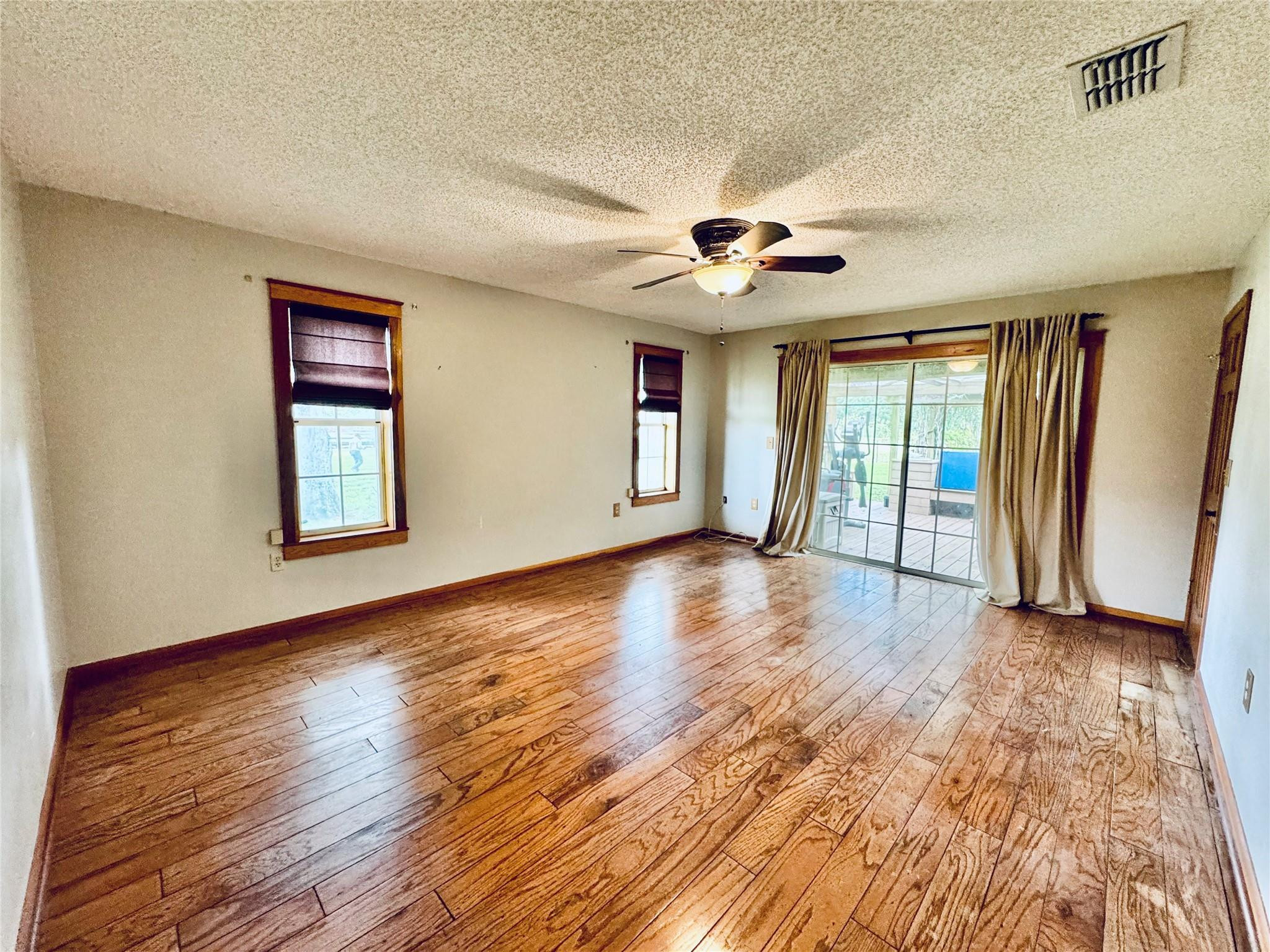 395 Southwest 30th Terrace Okeechobee, FL 34974 - Photo 18 of 57 a view of an empty room with a window and wooden floor