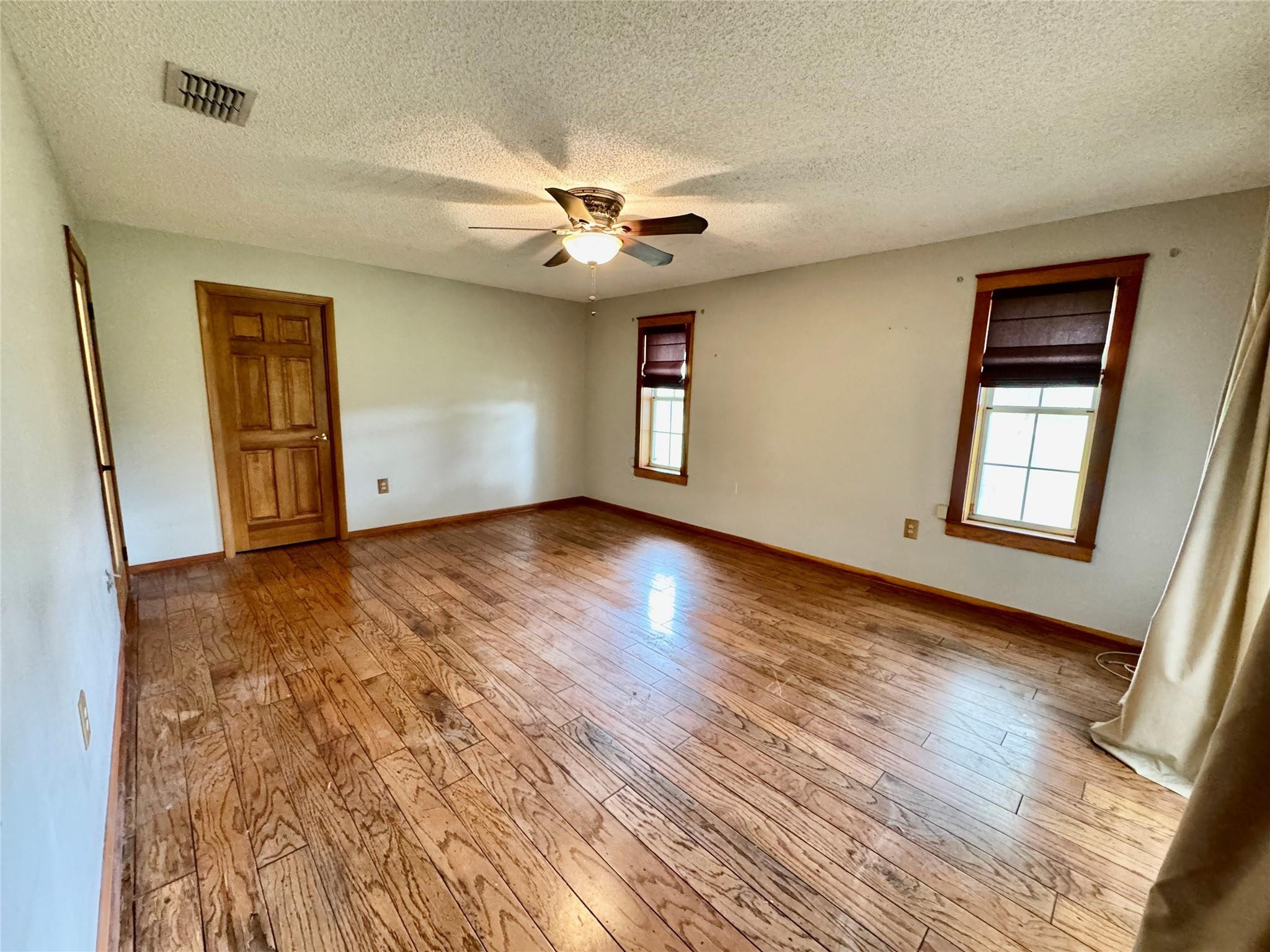 395 Southwest 30th Terrace Okeechobee, FL 34974 - Photo 19 of 57 a view of an empty room with a window and wooden floor
