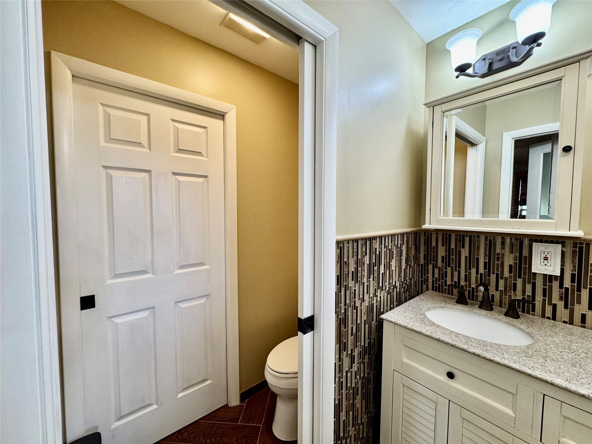 395 Southwest 30th Terrace Okeechobee, FL 34974 - Photo 25 of 57 a bathroom with a granite countertop toilet and a sink