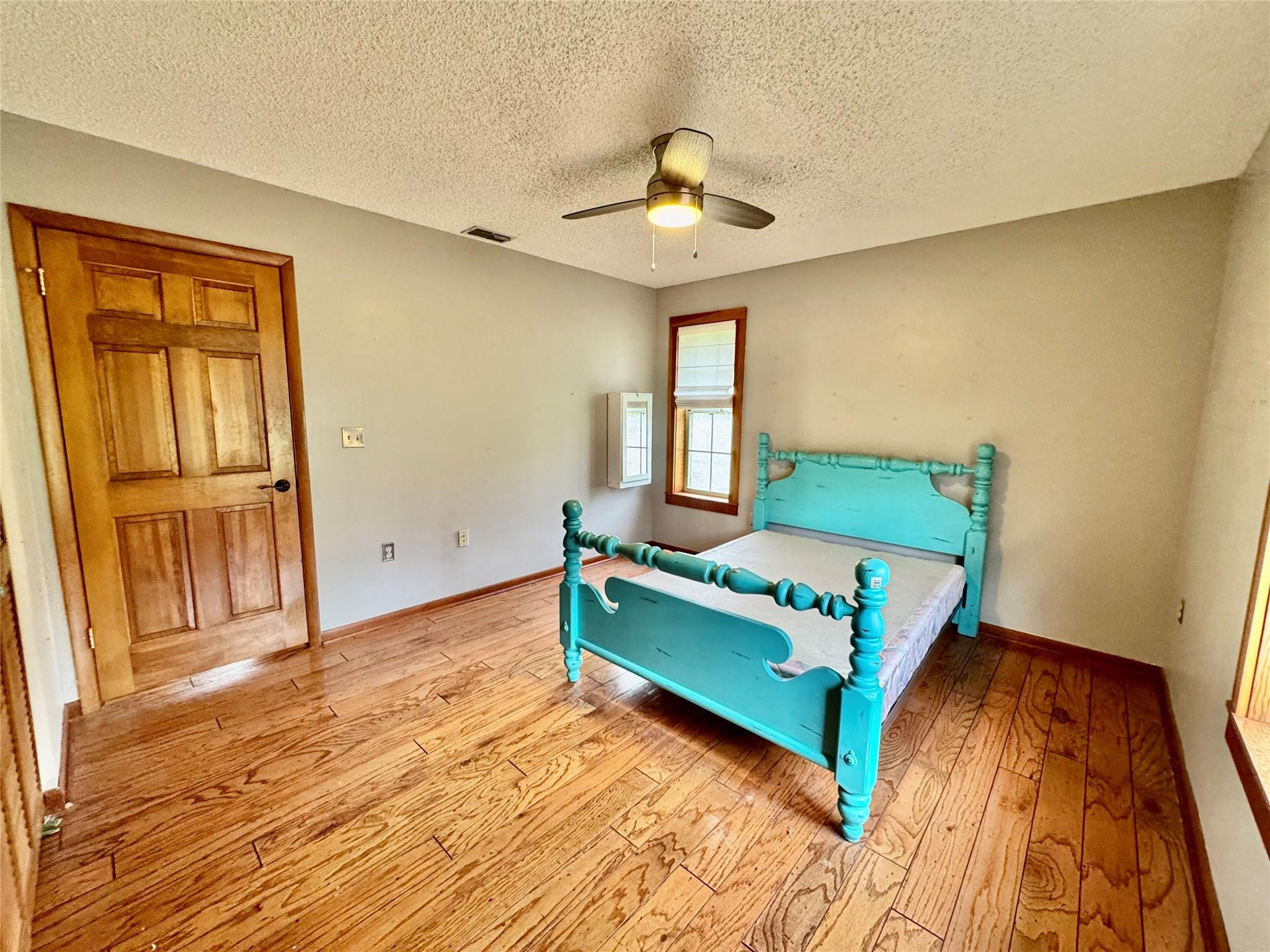 395 Southwest 30th Terrace Okeechobee, FL 34974 - Photo 26 of 57 a bedroom with a bed and a chandelier