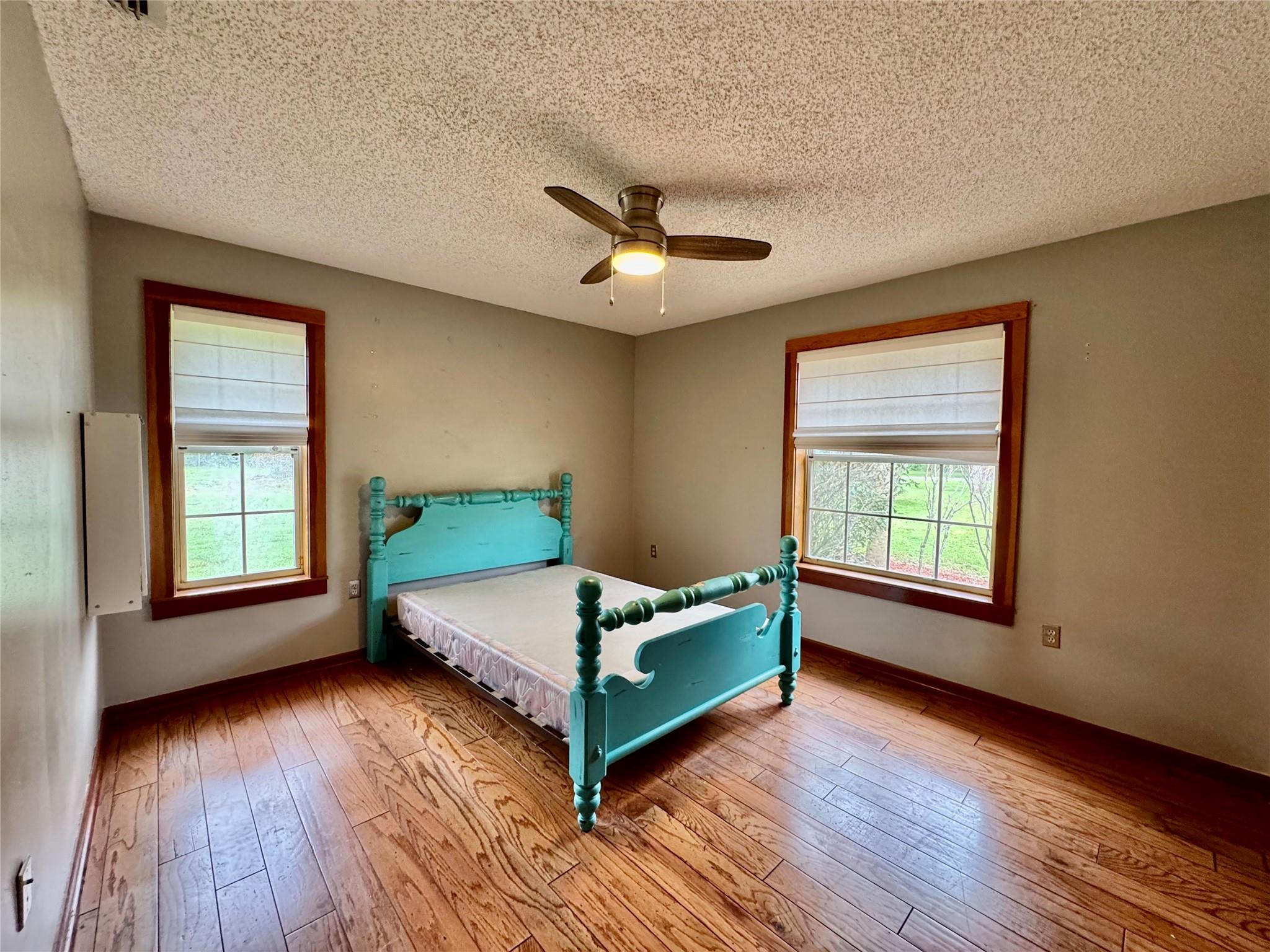 395 Southwest 30th Terrace Okeechobee, FL 34974 - Photo 27 of 57 a bedroom with a bed and wooden floor