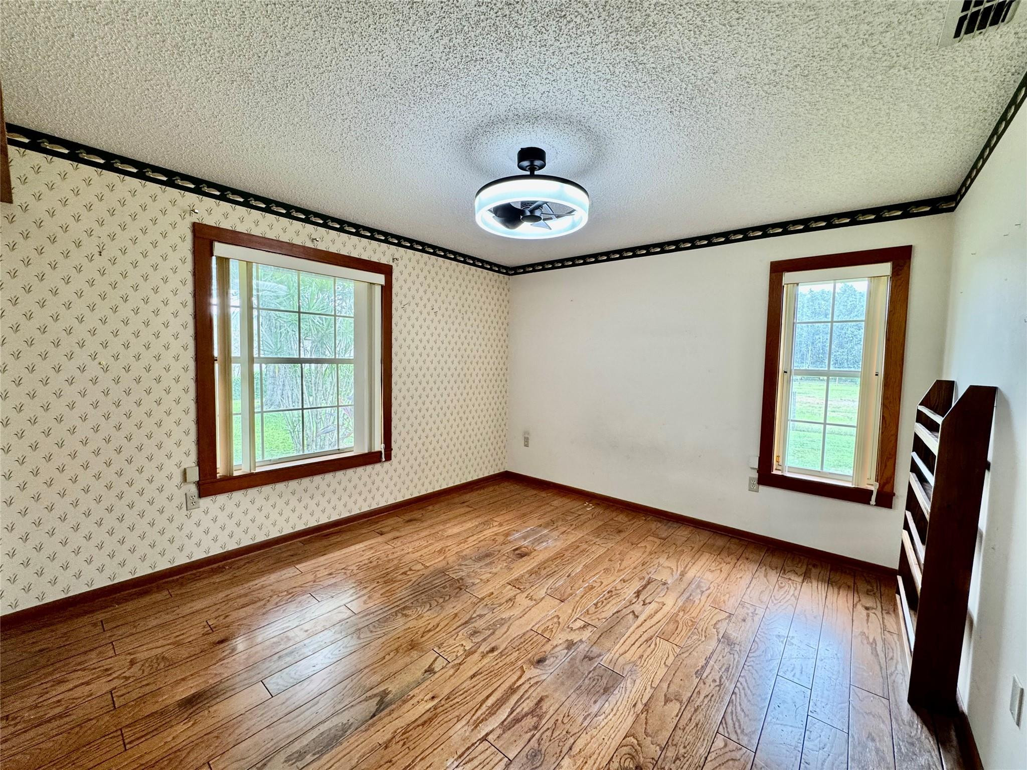 395 Southwest 30th Terrace Okeechobee, FL 34974 - Photo 28 of 57 a view of an empty room with window and wooden floor