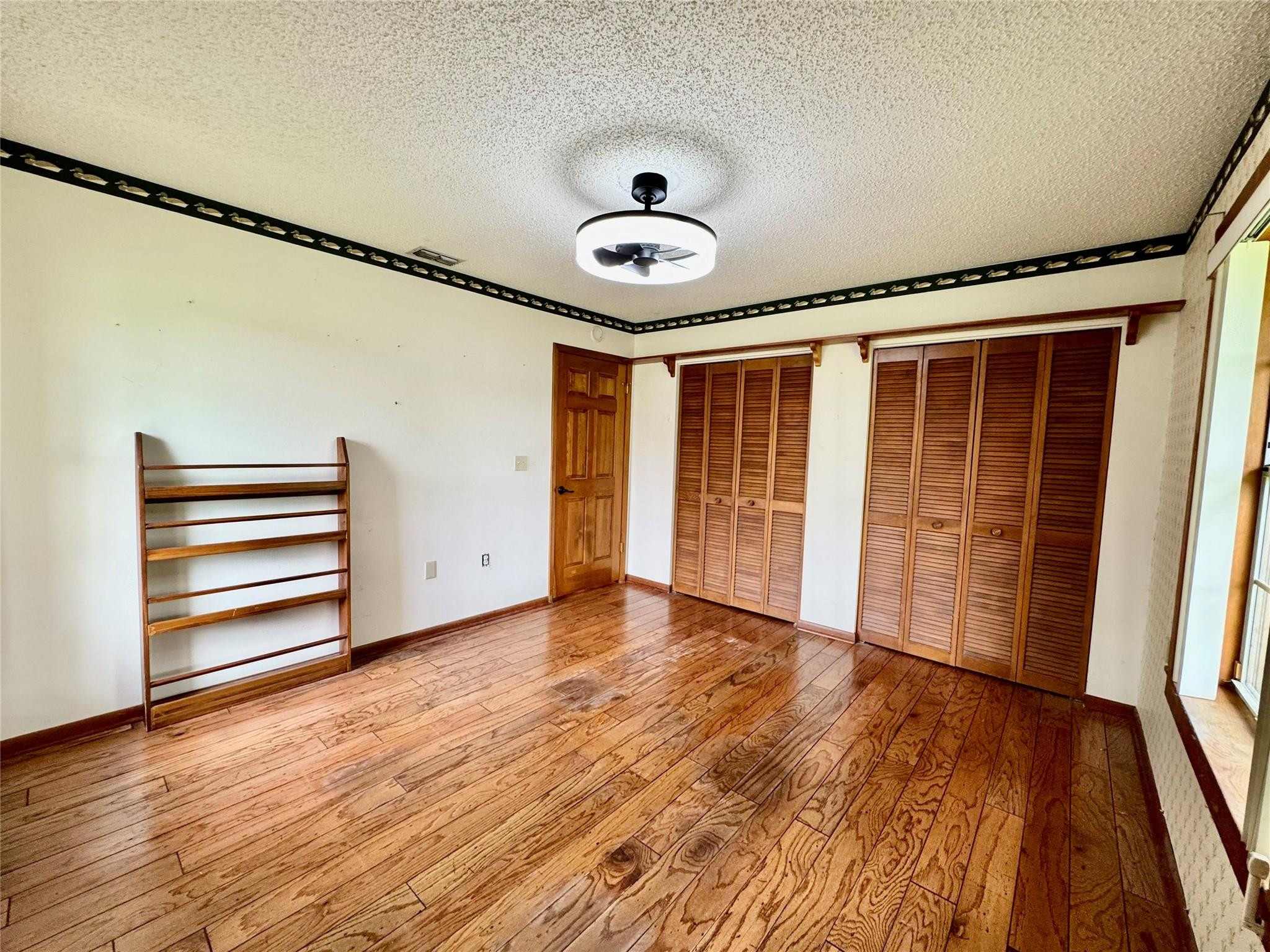 395 Southwest 30th Terrace Okeechobee, FL 34974 - Photo 30 of 57 a view of empty room with wooden floor