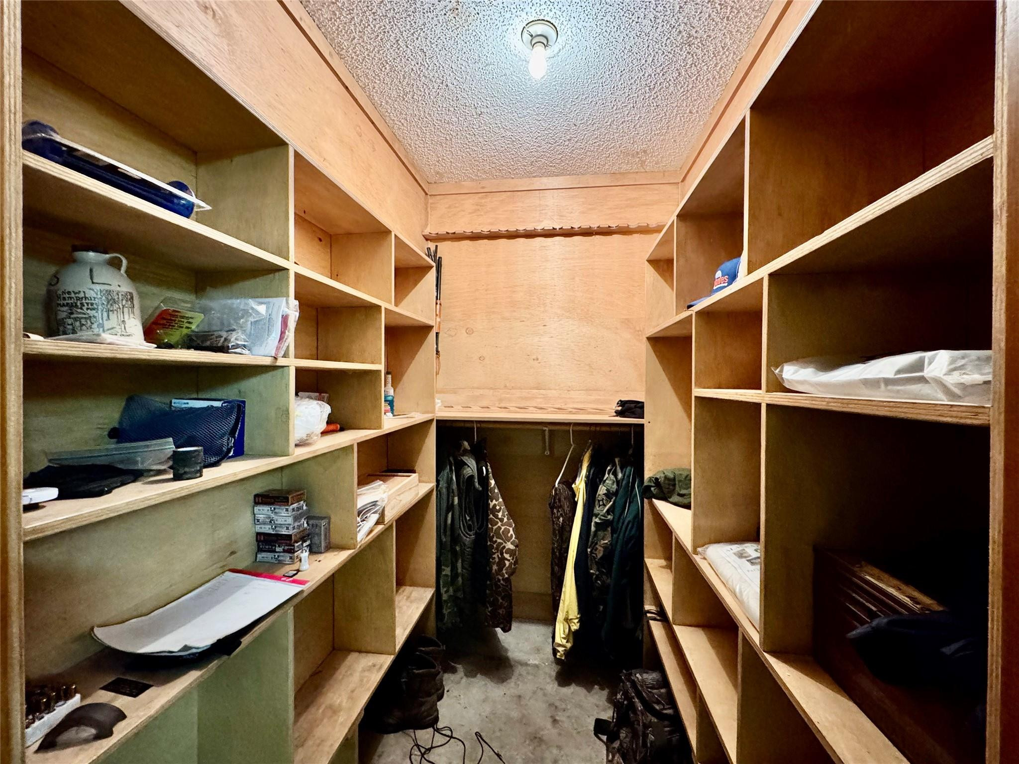 395 Southwest 30th Terrace Okeechobee, FL 34974 - Photo 38 of 57 a view of walk in closet with clothes and shoes