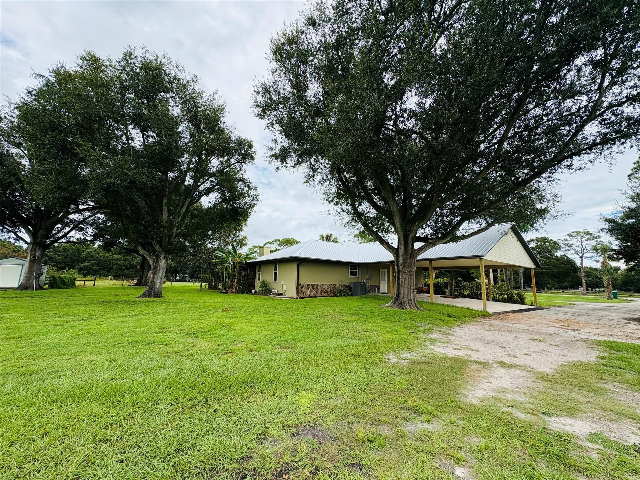 395 Southwest 30th Terrace Okeechobee, FL 34974 - Photo 44 of 57 a front view of a house with garden