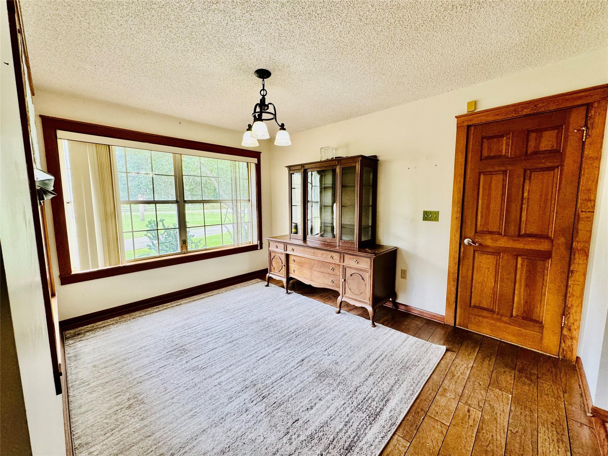 395 Southwest 30th Terrace Okeechobee, FL 34974 - Photo 9 of 57 wooden floor and windows in an empty room with a window