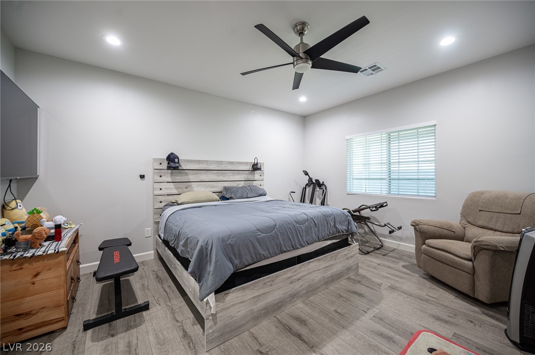 441 Belville Road Pahrump, NV 89048 - Photo 27 of 44 Relax in a cozy primary bedroom featuring light gray flooring and a modern ceiling fan.