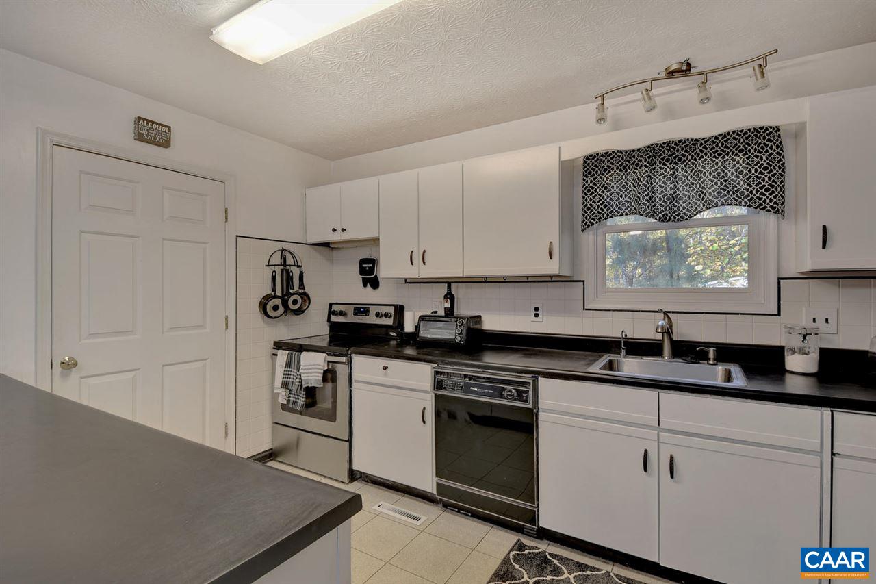 12 Laguna Road Palmyra, VA 22963 - Photo 14 of 50 a kitchen with granite countertop white cabinets and white appliances