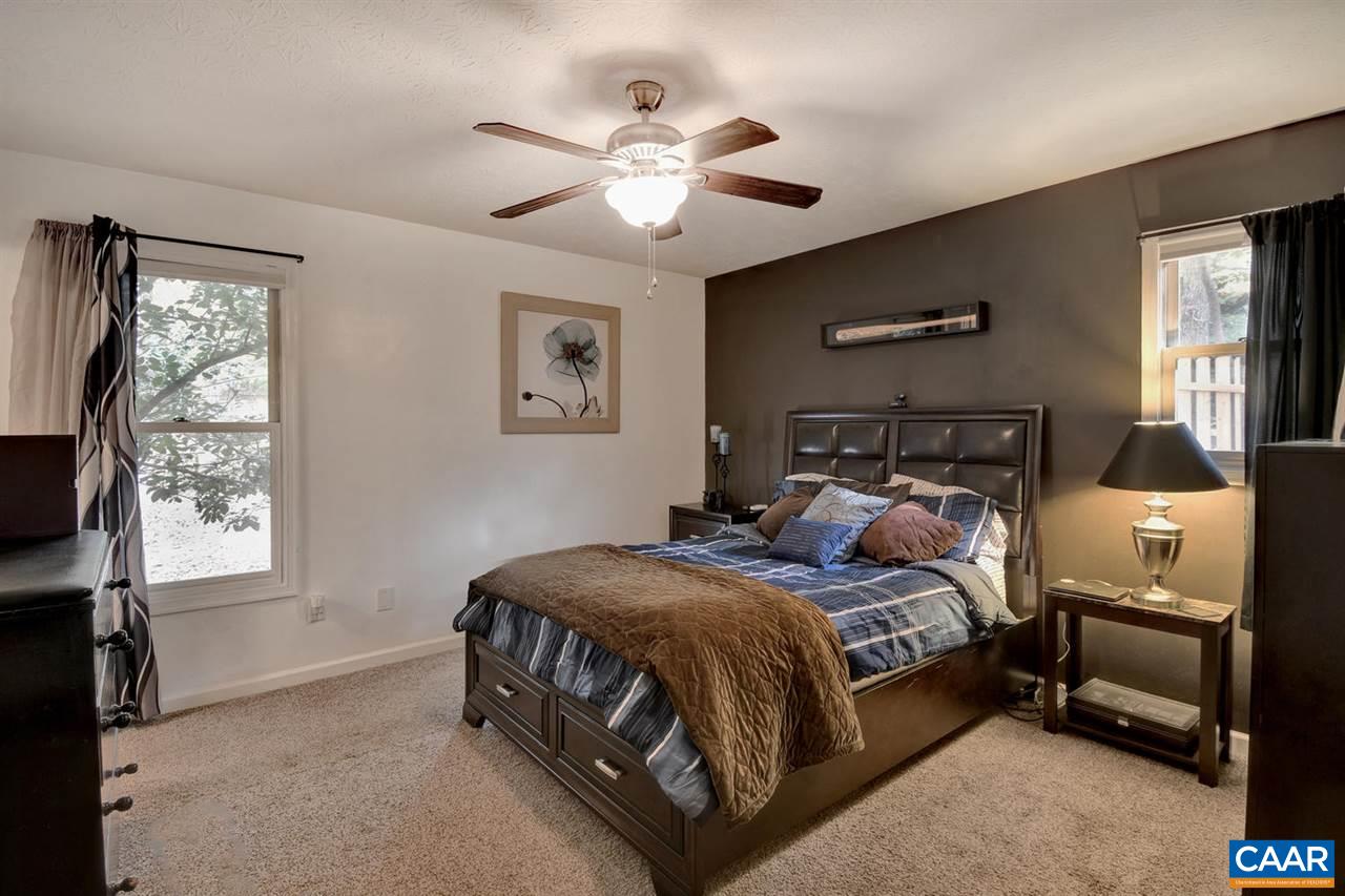 12 Laguna Road Palmyra, VA 22963 - Photo 19 of 50 a bedroom with a bed and a chandelier