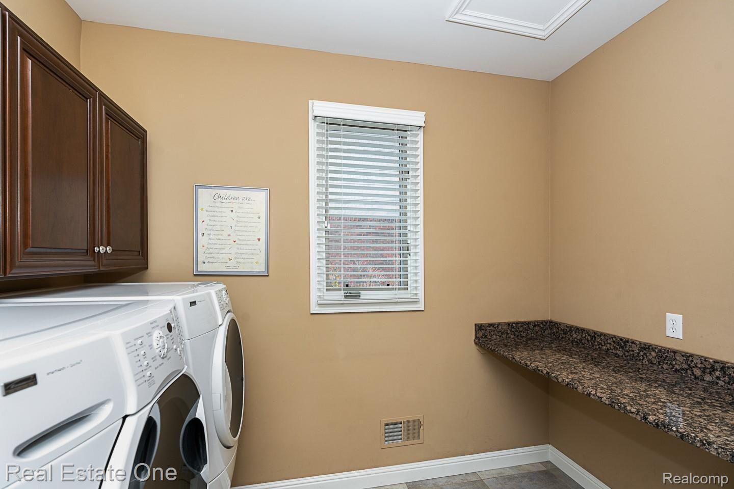 1577 Serene Court Rochester, MI 48306 - Photo 23 of 38 Laundry with cherry cabinets and countertop
