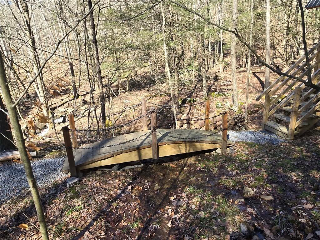 389 Winslow Hill Road Benezett, PA 15821 - Photo 15 of 33 a view of a yard with wooden fence and large trees