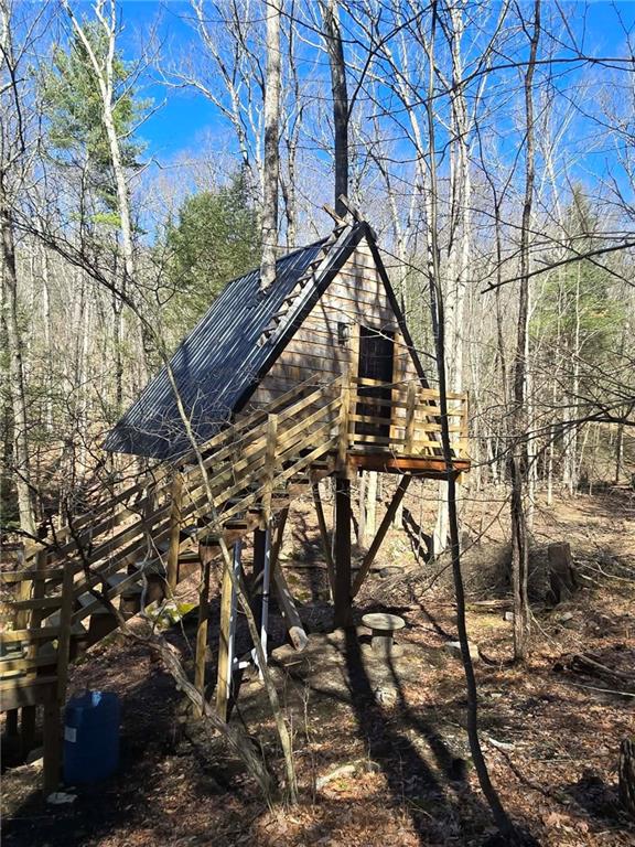 389 Winslow Hill Road Benezett, PA 15821 - Photo 16 of 33 a backyard of a house with lots of trees