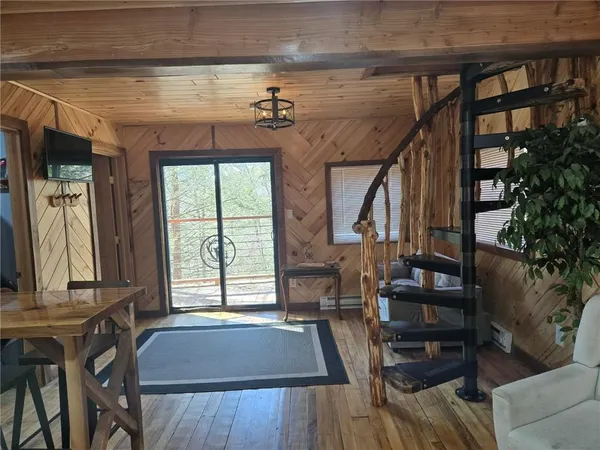 a kitchen with a sink a stove cabinets and a wooden floor