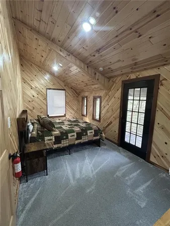 a bed sitting in a bedroom next to a larger window