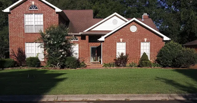 a front view of a house with a yard