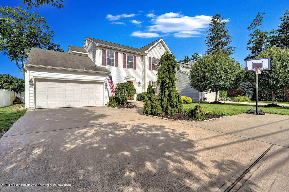 1505 Beaver Dam Road Point Pleasant, NJ 08742 - Photo 12 of 48 a front view of a house with a yard and a garage