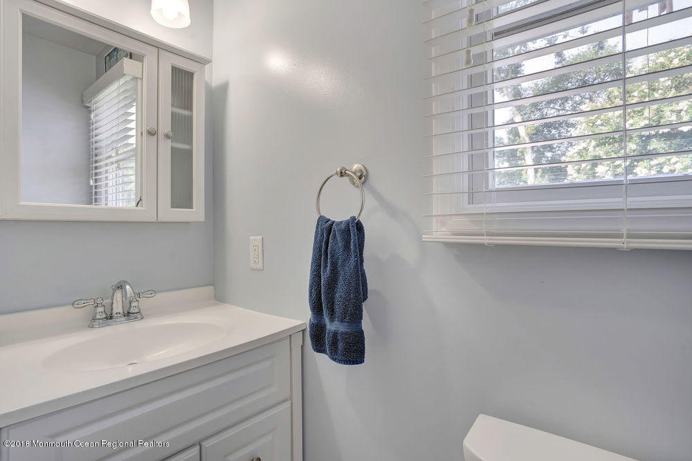 1505 Beaver Dam Road Point Pleasant, NJ 08742 - Photo 34 of 48 a bathroom with a sink a toilet and a mirror