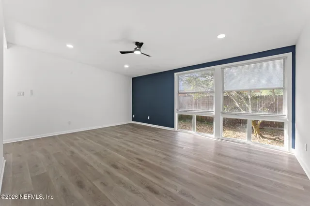 a kitchen with stainless steel appliances granite countertop a sink a stove a refrigerator and island with wooden floor