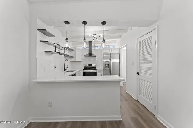 a view of a backyard with a garden and entertaining space