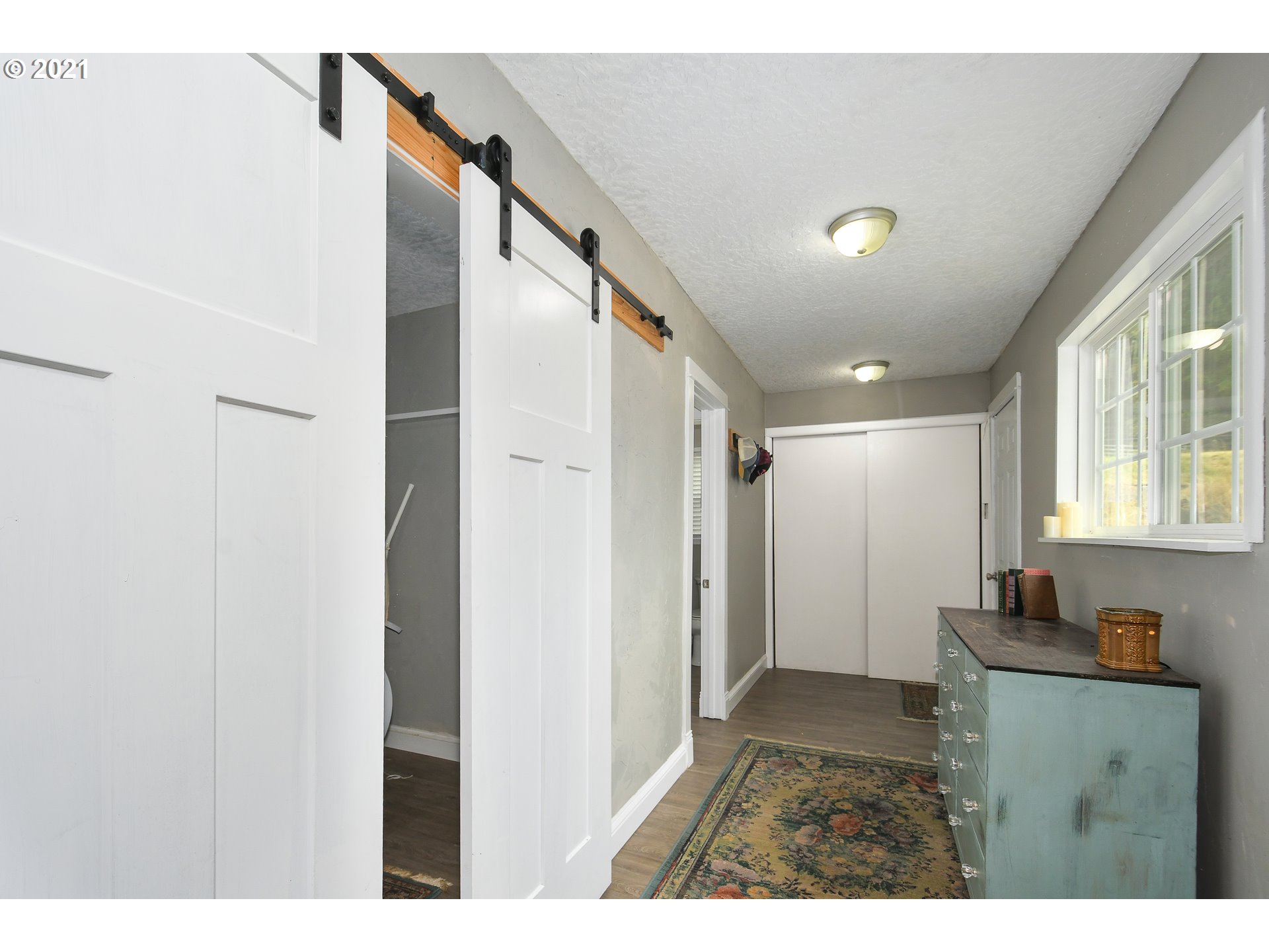 20512 Northeast Risto Road Battle Ground, WA 98604 - Photo 19 of 28 a view of hallway with a large window and wooden floor