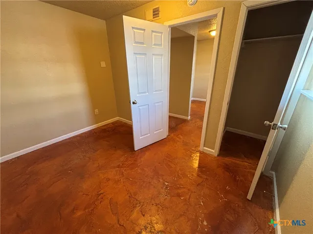 an empty room with wooden floor